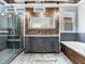 Bathroom featuring a soaking tub, frameless shower, double vanity, and plank ceiling at 3003 W Leila Ave, Tampa, FL 33611