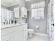 Stylish bathroom featuring a white vanity, marble countertop, and neutral color palette at 3003 W Leila Ave, Tampa, FL 33611