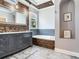 Bathroom showcasing a soaking tub, vanity, tile flooring and backsplash at 3003 W Leila Ave, Tampa, FL 33611