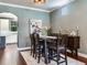 Stylish dining area with modern lighting, hardwood floors, and a view into the kitchen at 3003 W Leila Ave, Tampa, FL 33611