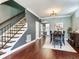 Spacious dining area with a staircase, a view into the kitchen, and hardwood floors at 3003 W Leila Ave, Tampa, FL 33611