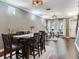 Open concept dining area with hardwood floors, modern lighting, and adjacent seating area at 3003 W Leila Ave, Tampa, FL 33611