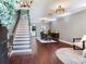 Elegant entryway with dark wood floors, staircase, and formal dining area at 3003 W Leila Ave, Tampa, FL 33611
