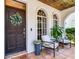 Cozy front porch with comfortable seating, decorative accents, and a wood paneled ceiling at 3003 W Leila Ave, Tampa, FL 33611