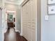 Hallway with a closet and hardwood floors leading into a bedroom at 3003 W Leila Ave, Tampa, FL 33611