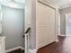 Hallway with a closet, hardwood floors and stairs, with views to a bathroom at 3003 W Leila Ave, Tampa, FL 33611