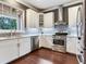 Modern kitchen showcasing stainless steel appliances, gray backsplash, and ample cabinet space at 3003 W Leila Ave, Tampa, FL 33611
