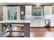 Bright kitchen features white cabinets, stainless steel appliances, marble counters and center island at 3003 W Leila Ave, Tampa, FL 33611