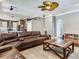 Open-concept living room features a sectional couch and seamlessly connects to the kitchen at 3003 W Leila Ave, Tampa, FL 33611