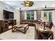 Inviting living room with sectional couch, television, and backyard views at 3003 W Leila Ave, Tampa, FL 33611
