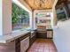 Outdoor kitchen featuring a grill, countertop, and wood ceiling at 3003 W Leila Ave, Tampa, FL 33611