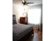 Bright bedroom featuring a comfortable bed, wooden dresser, and hardwood flooring, creating a peaceful retreat at 311 Kelsey Way # 3, Sun City Center, FL 33573