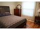 Bedroom featuring hardwood floors, wood furniture, and a large window with natural light at 311 Kelsey Way # 3, Sun City Center, FL 33573