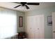 Bedroom featuring a window, closet, ceiling fan with lighting and neutral wall colors, providing a cozy space at 311 Kelsey Way # 3, Sun City Center, FL 33573