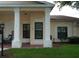 Inviting front porch with brick flooring and decorative pillars at 311 Kelsey Way # 3, Sun City Center, FL 33573