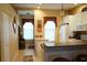 Bright kitchen featuring white cabinets, tile floors, and a breakfast bar, perfect for casual dining at 311 Kelsey Way # 3, Sun City Center, FL 33573