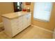 Functional kitchen island with storage cabinets and drawers, providing additional workspace and convenience at 311 Kelsey Way # 3, Sun City Center, FL 33573