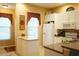 Bright eat-in kitchen featuring white cabinetry, a center island and an abundance of natural light at 311 Kelsey Way # 3, Sun City Center, FL 33573