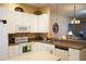 Well-lit kitchen with white appliances and ample counter space, ideal for cooking and entertaining at 311 Kelsey Way # 3, Sun City Center, FL 33573