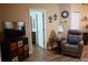 Cozy living room features wood floors, a TV, and a comfortable chair at 311 Kelsey Way # 3, Sun City Center, FL 33573