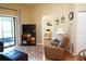 Relaxing living area featuring hardwood floors, a comfortable recliner, and an adjoining bedroom at 311 Kelsey Way # 3, Sun City Center, FL 33573