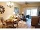 Cozy living room with hardwood floors, a chandelier, comfortable furniture, and sliding door access at 311 Kelsey Way # 3, Sun City Center, FL 33573