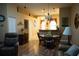 Inviting living room and dining area with hardwood floors and stylish chandelier lighting at 311 Kelsey Way # 3, Sun City Center, FL 33573