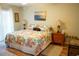 Serene main bedroom featuring a queen-sized bed, bedside tables, and abundant natural light at 311 Kelsey Way # 3, Sun City Center, FL 33573