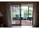 A screened patio with comfortable chairs and a view of the surrounding neighborhood at 311 Kelsey Way # 3, Sun City Center, FL 33573