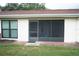 Back patio with a screen door, offering a peaceful outdoor seating area with a view of the backyard at 311 Kelsey Way # 3, Sun City Center, FL 33573