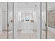 Bright bathroom featuring dual mirrors, white cabinets, and tile flooring at 3702 54Th W Dr # 104, Bradenton, FL 34210
