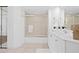 Bright bathroom featuring a shower over tub, white cabinets, and tile flooring at 3702 54Th W Dr # 104, Bradenton, FL 34210