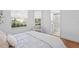 Well-lit bedroom with two windows, chair and view of an ensuite bathroom at 3702 54Th W Dr # 104, Bradenton, FL 34210