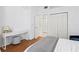 Bedroom features a desk, a large closet, hardwood floors, and a comfortable bed at 3702 54Th W Dr # 104, Bradenton, FL 34210