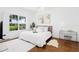 Bright bedroom featuring a plush bed, contemporary art, and large window offering natural light at 3702 54Th W Dr # 104, Bradenton, FL 34210