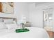 Bright bedroom featuring white bedding, hardwood floors, and a modern decor at 3702 54Th W Dr # 104, Bradenton, FL 34210