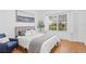 Cozy bedroom featuring hardwood floors, a large window, and a comfortable bed at 3702 54Th W Dr # 104, Bradenton, FL 34210