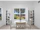 Cozy dining area with a white table and chairs, and a lovely view through shuttered windows at 3702 54Th W Dr # 104, Bradenton, FL 34210