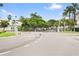 Secured entrance gate to the neighborhood with lush tropical landscaping at 3702 54Th W Dr # 104, Bradenton, FL 34210