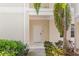 Close up entryway of condo with white door and well maintained landscape at 3702 54Th W Dr # 104, Bradenton, FL 34210