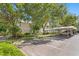 Beautiful two-story home with a white roof, lush landscaping, and covered parking spaces for convenient vehicle storage at 3702 54Th W Dr # 104, Bradenton, FL 34210