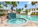 Inviting hot tub with tropical foliage, buildings and pool in the background at 3702 54Th W Dr # 104, Bradenton, FL 34210