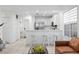 Well-lit kitchen featuring a breakfast bar with stools, stainless steel appliances, and open floor plan to living area at 3702 54Th W Dr # 104, Bradenton, FL 34210