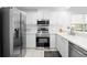 Modern kitchen boasts stainless steel appliances, white cabinetry, and ample counter space for food preparation at 3702 54Th W Dr # 104, Bradenton, FL 34210