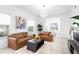 Well-lit living room with modern decor, comfortable seating and views to the adjoining dining area at 3702 54Th W Dr # 104, Bradenton, FL 34210