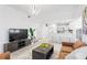 Bright and inviting living room with modern lighting and an open-concept kitchen with bar seating at 3702 54Th W Dr # 104, Bradenton, FL 34210