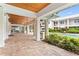 Expansive patio area with wood-paneled ceiling and views of the lush landscaping and inviting pool at 3702 54Th W Dr # 104, Bradenton, FL 34210