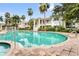 Beautiful pool surrounded by lush greenery and elegant two-story buildings, ideal for a refreshing swim at 3702 54Th W Dr # 104, Bradenton, FL 34210