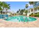 Beautiful community pool surrounded by lush tropical landscaping and palm trees at 3702 54Th W Dr # 104, Bradenton, FL 34210