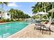 Resort-style pool area with comfortable lounge chairs and lush landscaping, perfect for relaxation at 3702 54Th W Dr # 104, Bradenton, FL 34210